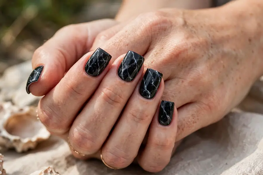 Black marble nails with white veining on square nails