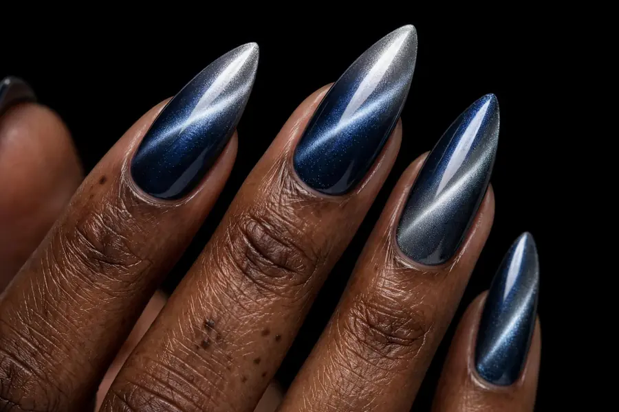 Stiletto nails with midnight blue-to-silver two tone cat eye nail polish, magnetic light band