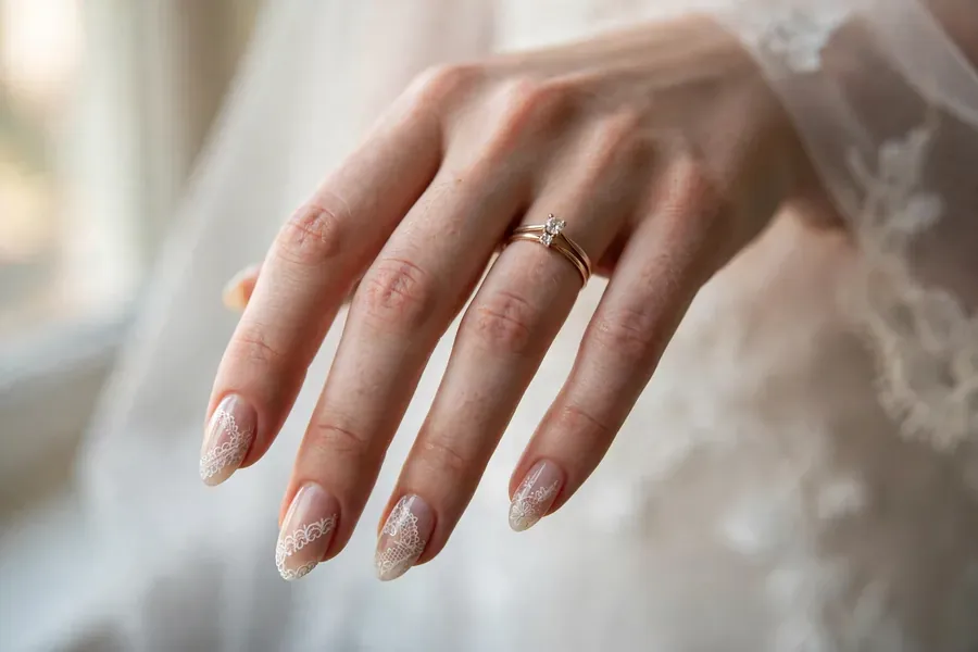 Bridal nails with hand-painted white lace patterns
