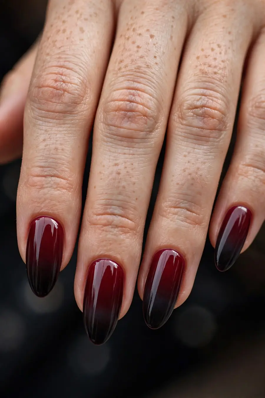 Ombré nails fading from burgundy to black