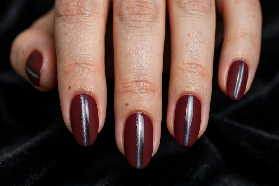 Matte oxblood dark red cat eye nails with a glossy magnetic stripe