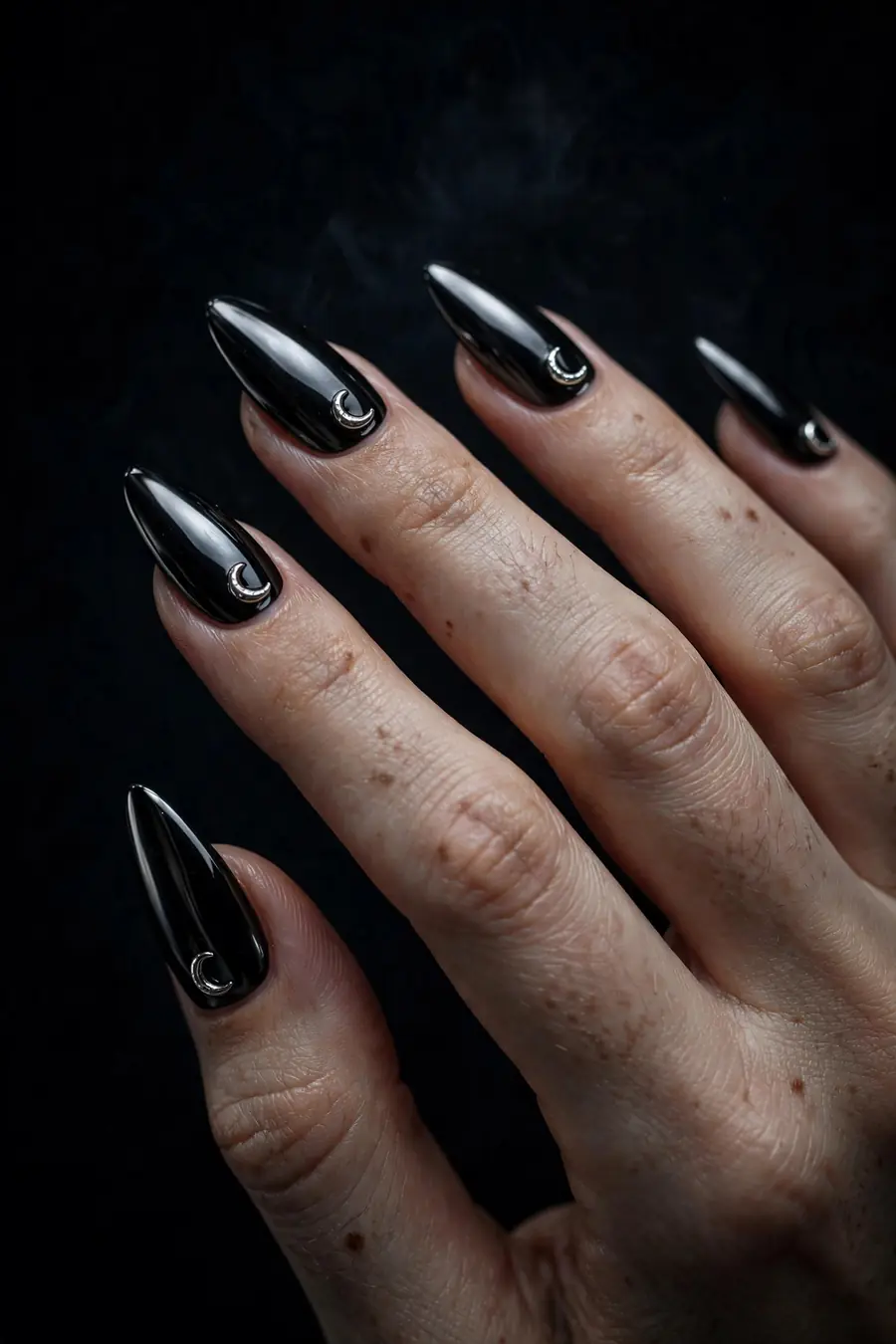 Black gothic chrome nails with silver crescent moon accents