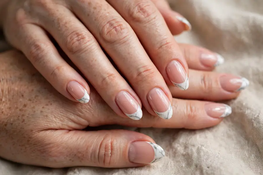 French tip nails with marble veining on the tips