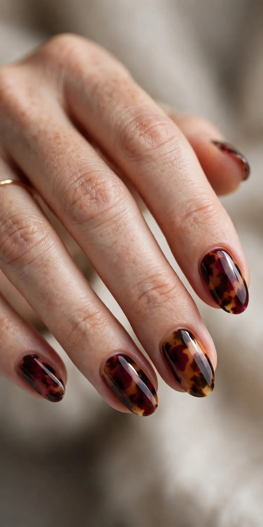 Tortoiseshell nail art blended with burgundy tones