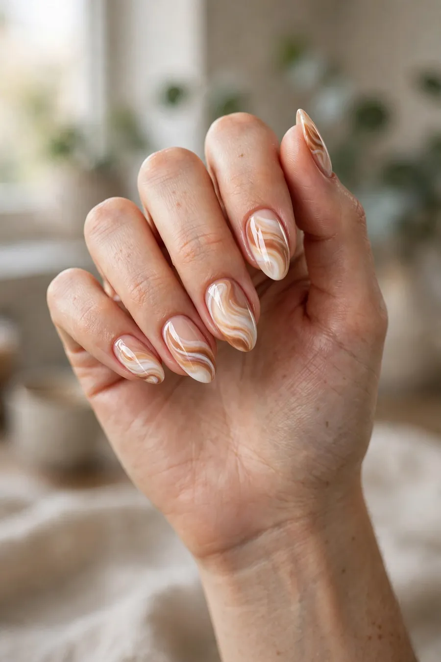 Caramel nude nails with white and caramel swirl nail art