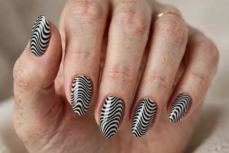 Op-art black and white wavy almond nails stripes on real hands