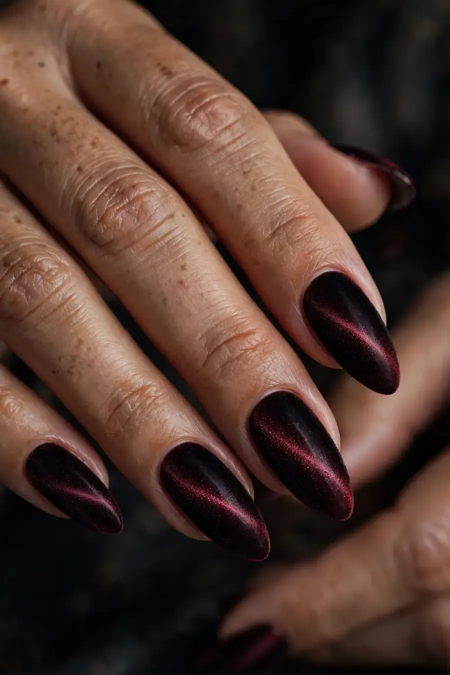 Black to burgundy velvet ombre nails on real hands