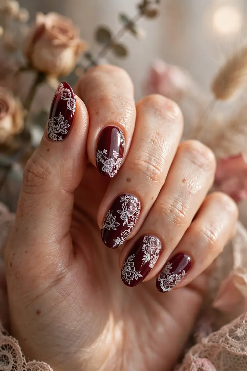 Burgundy nails with white lace stamping details