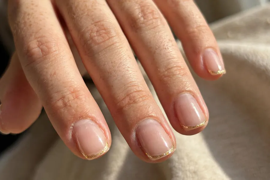 Gold glitter micro French tip nails