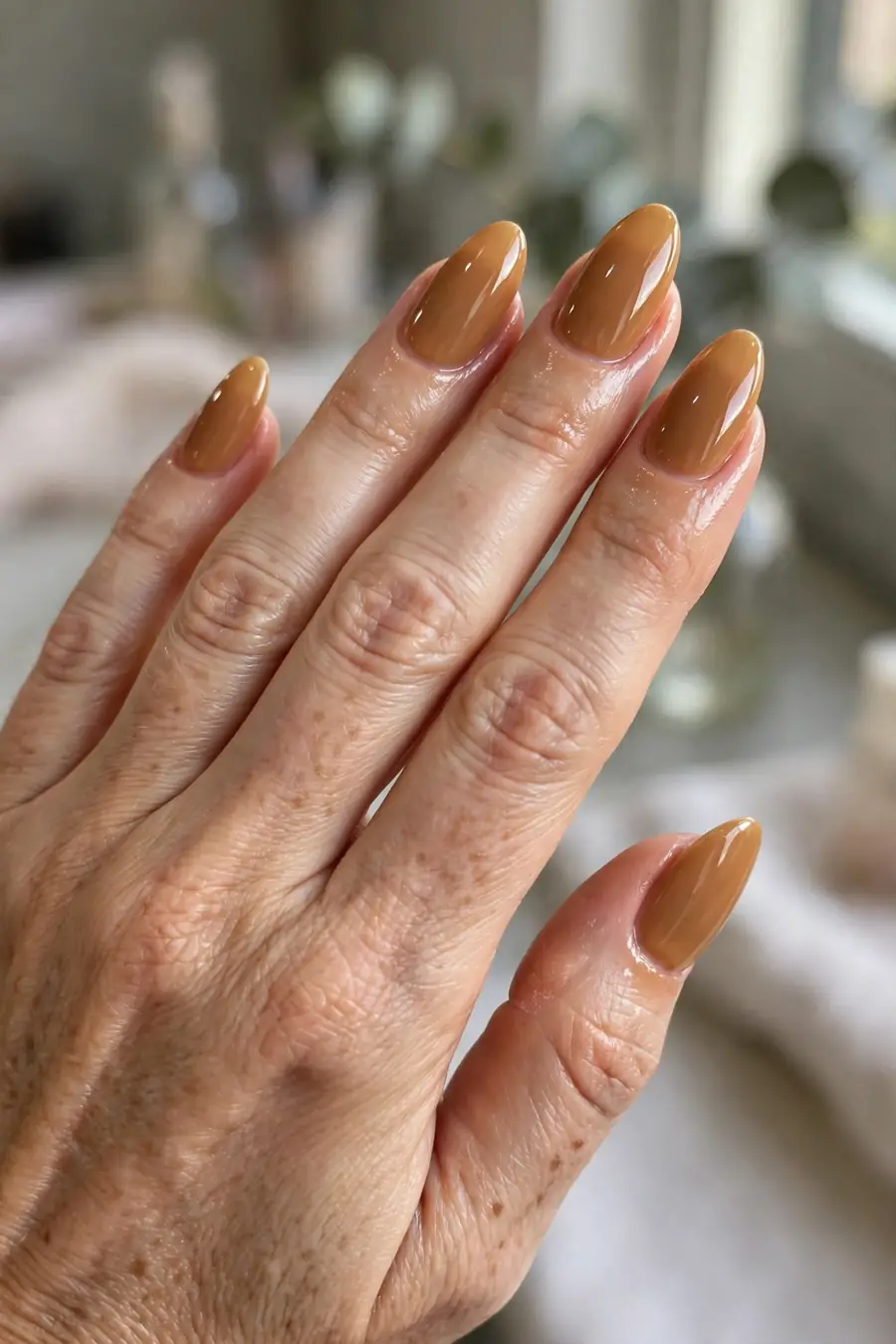 Honey-toned caramel nude nails with ultra-glossy wet-look glaze