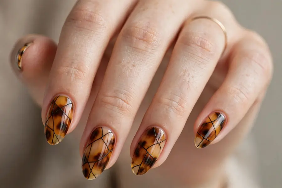 Tortoiseshell almond nails stripes with dark lines on real hands