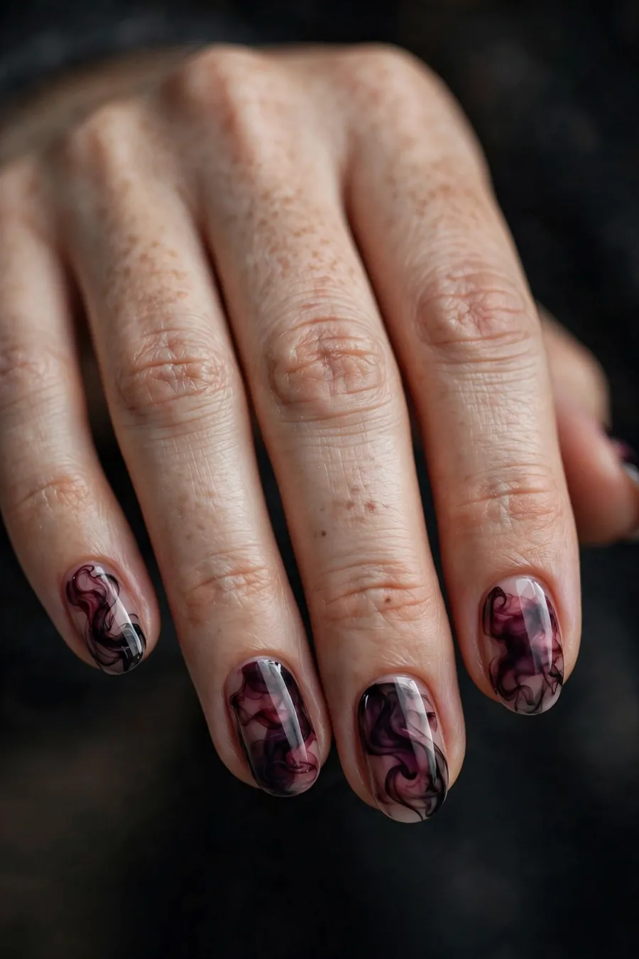 Smoky swirl nail art in burgundy and black
