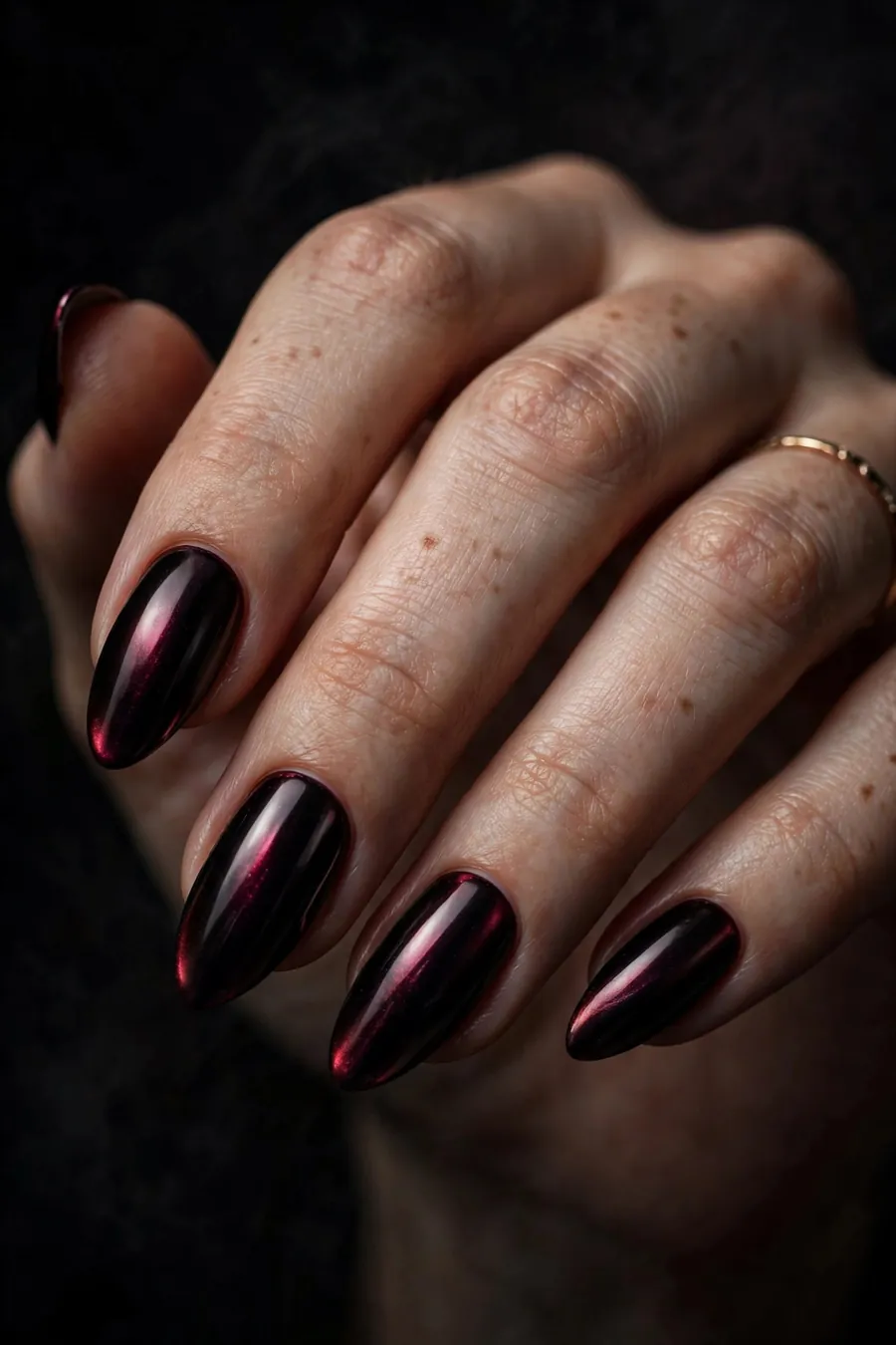 Wine-black gothic chrome nails with burgundy glow