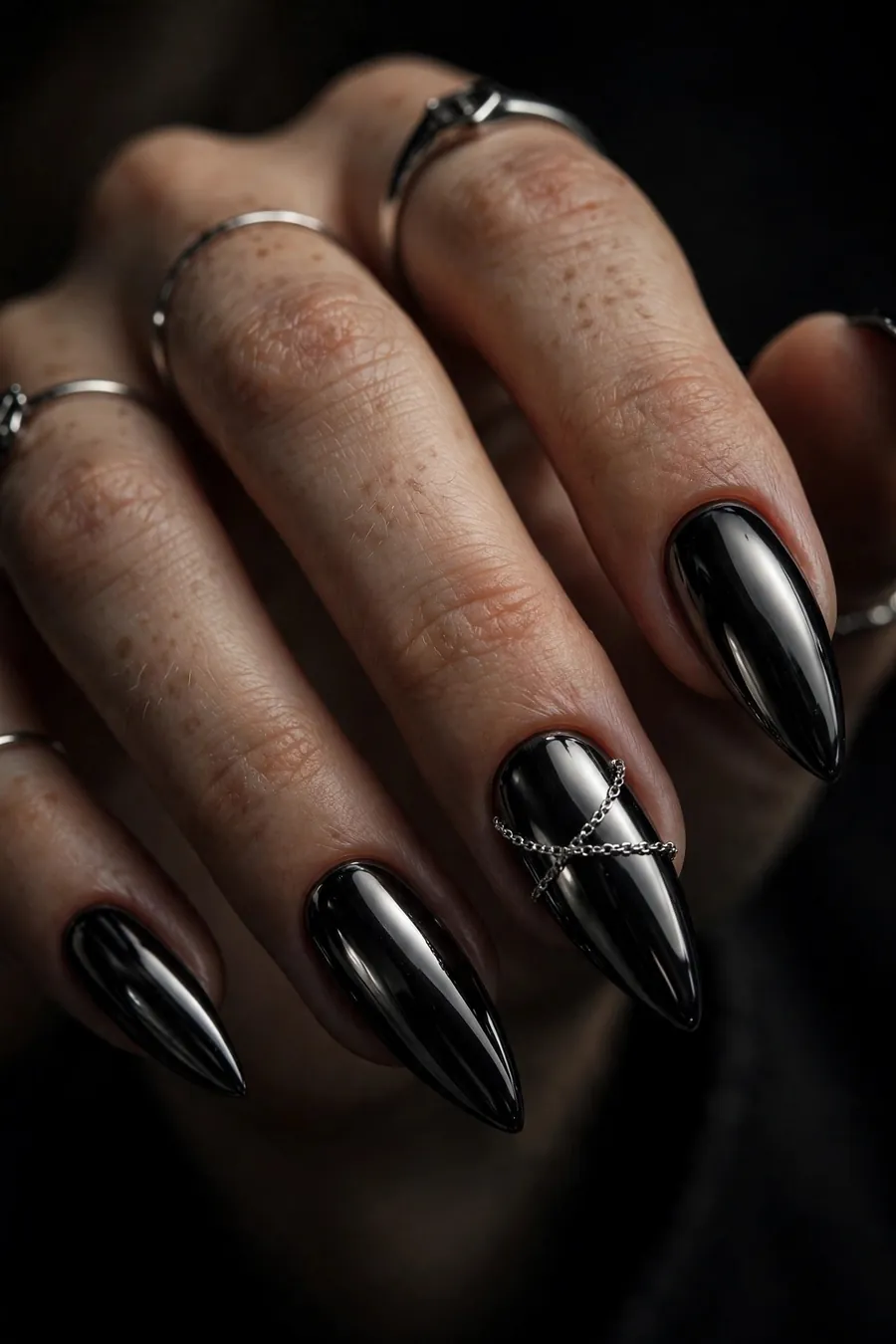 Black gothic chrome nails with chain accent