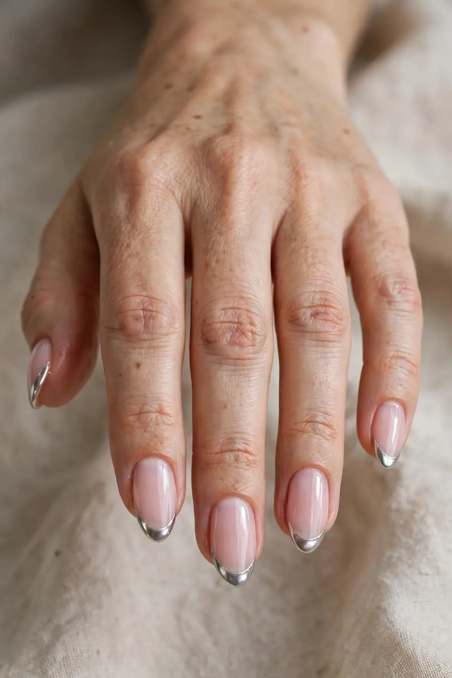 Bubble bath nails with silver chrome French tips on real hands