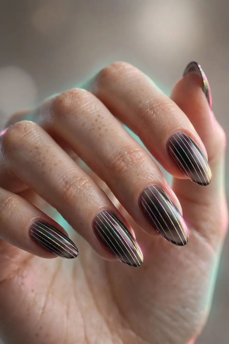 Holographic line art striped almond nails on real hands