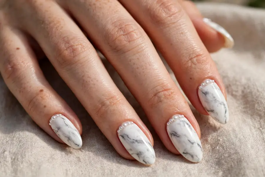 White marble nails with pearl accents