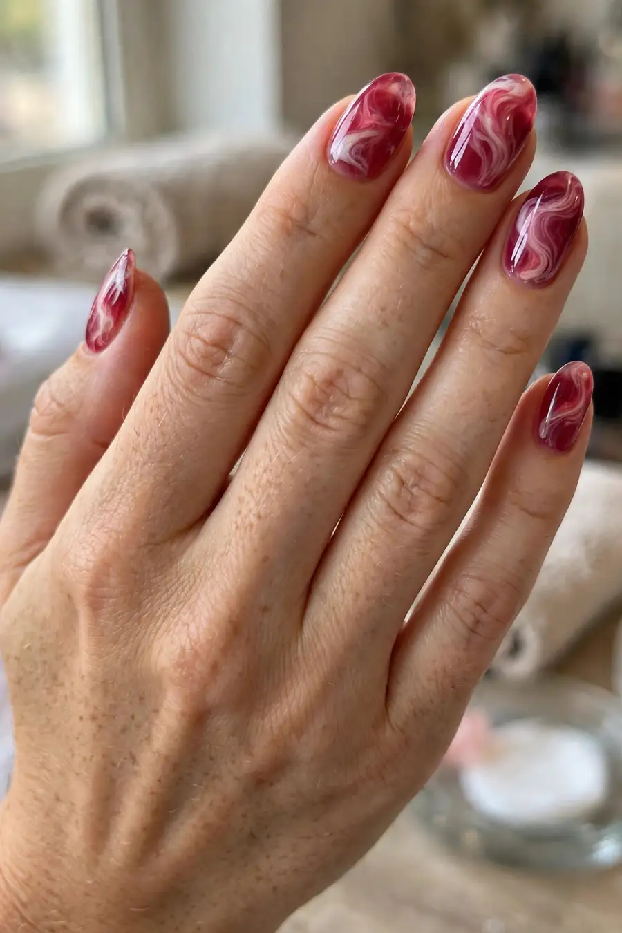 Raspberry jelly nails with soft marble swirl detailing
