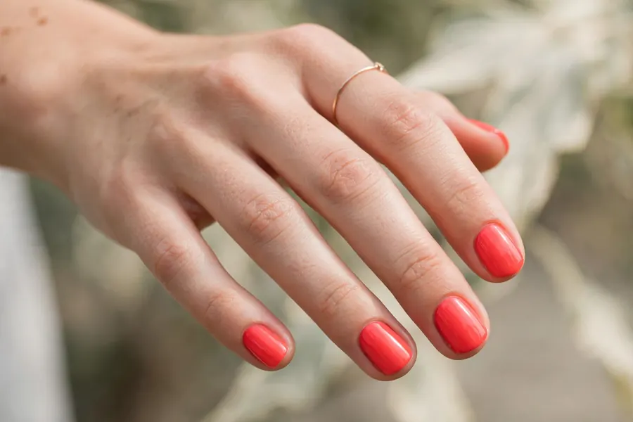 Coral bright short nail designs on real hands