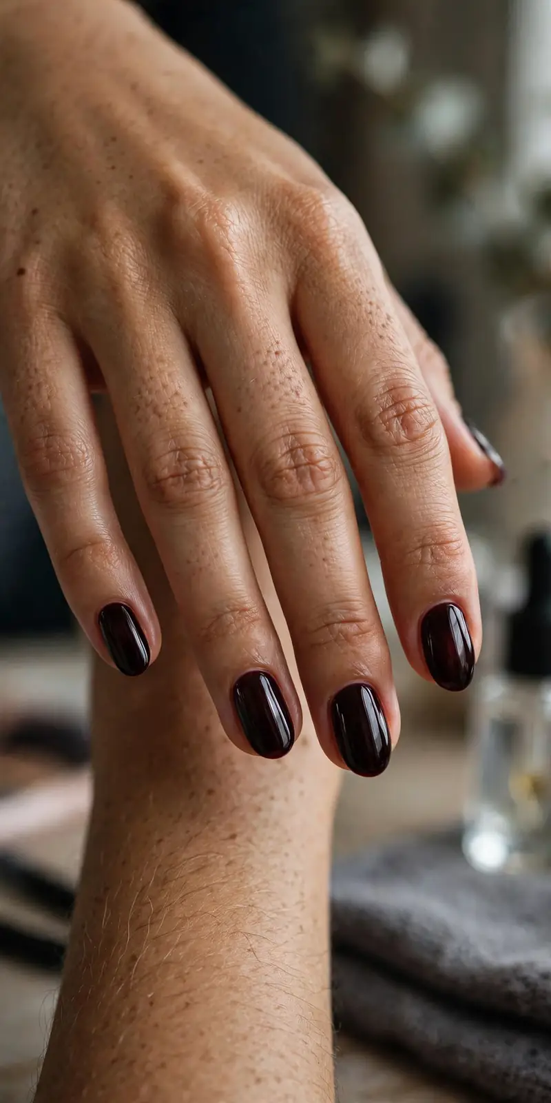 Dark cherry-toned raspberry jelly nails on short almond nails