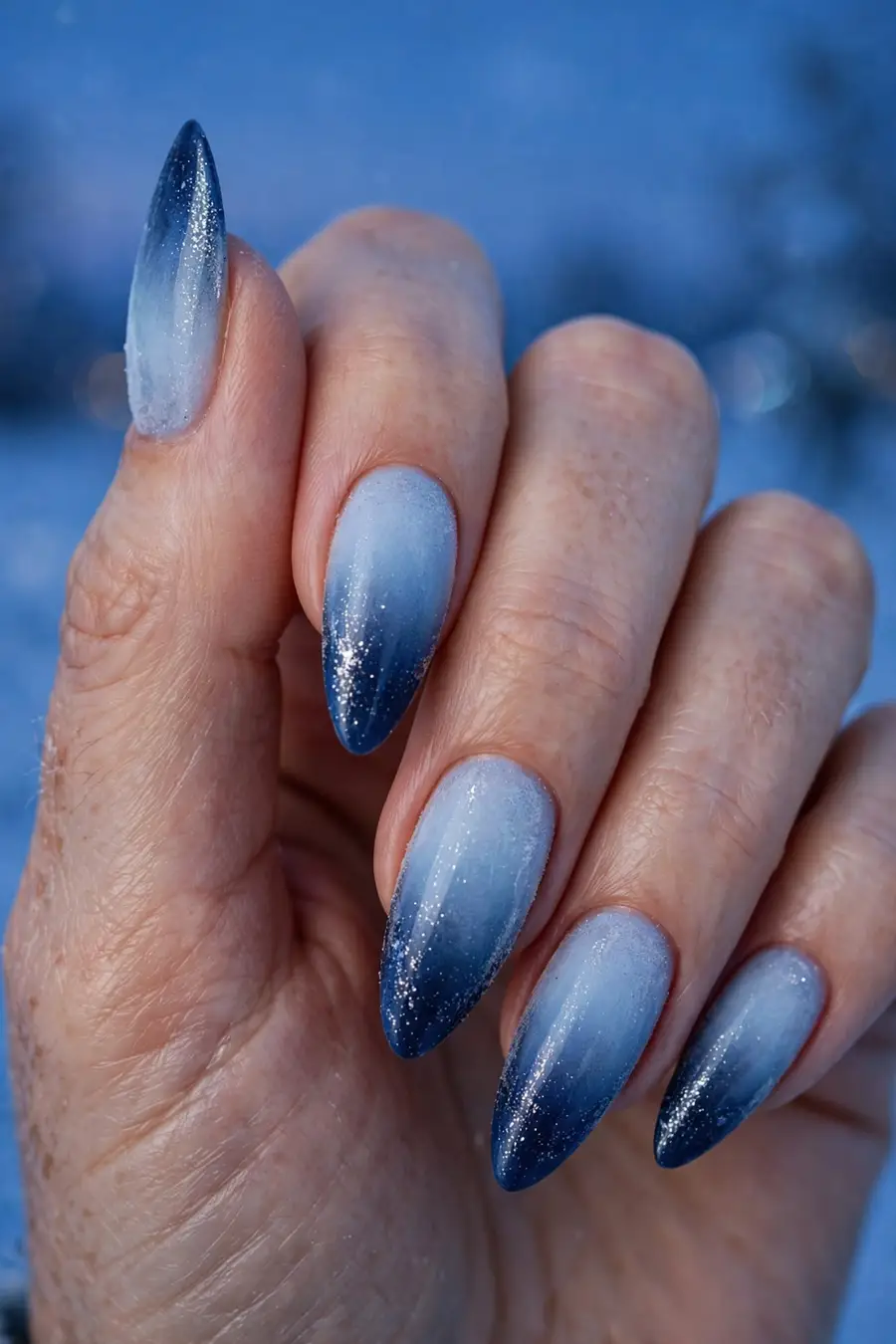 Frosty blue ombre december nail ideas melting from icy pale blue to deep navy