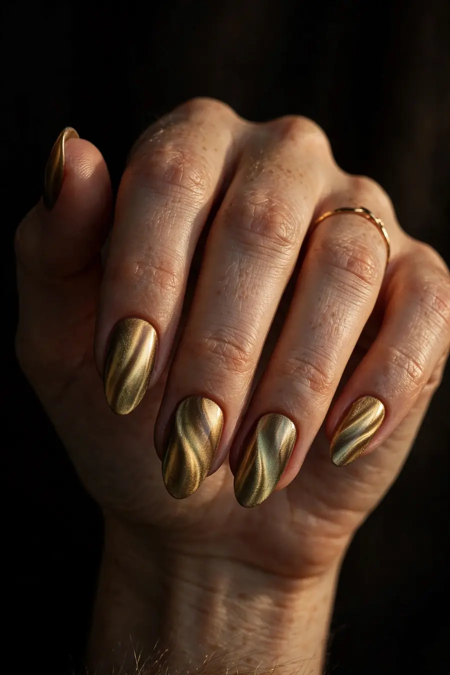 Hand with velvet gold magnetic chrome nails