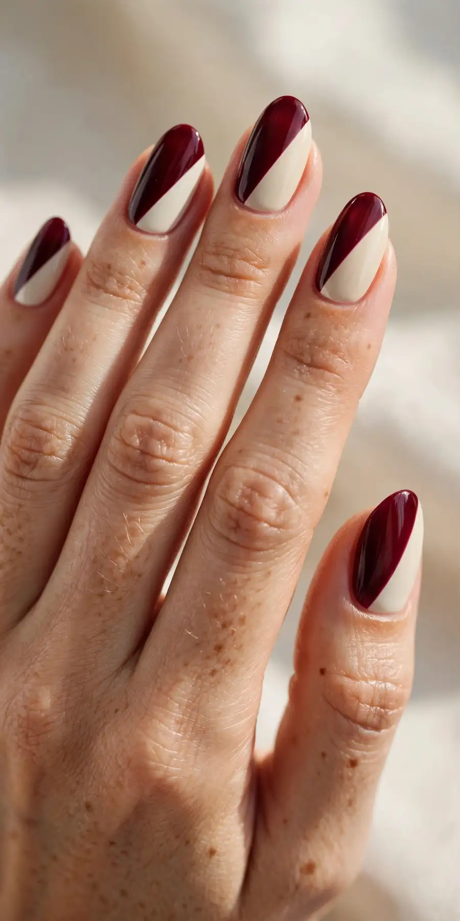 Colorblock nails in burgundy and cream