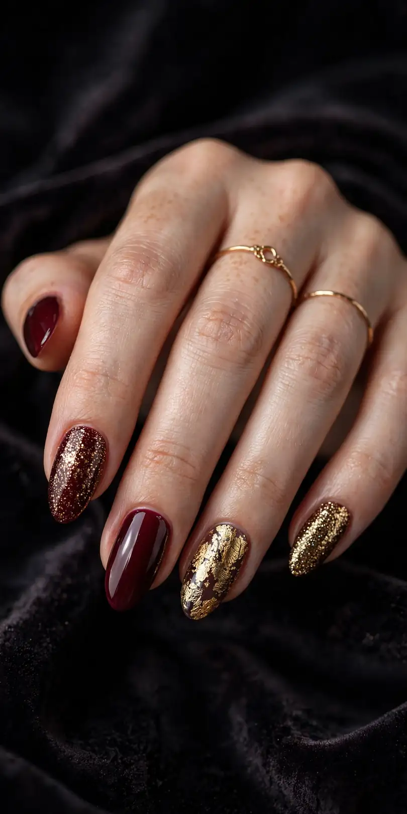 Deep burgundy and gold New Year's Eve nails