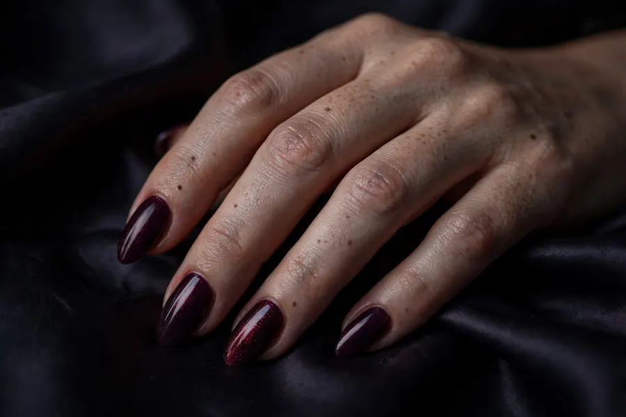 Midnight kiss Valentine's Day nails in deep plum with red shimmer